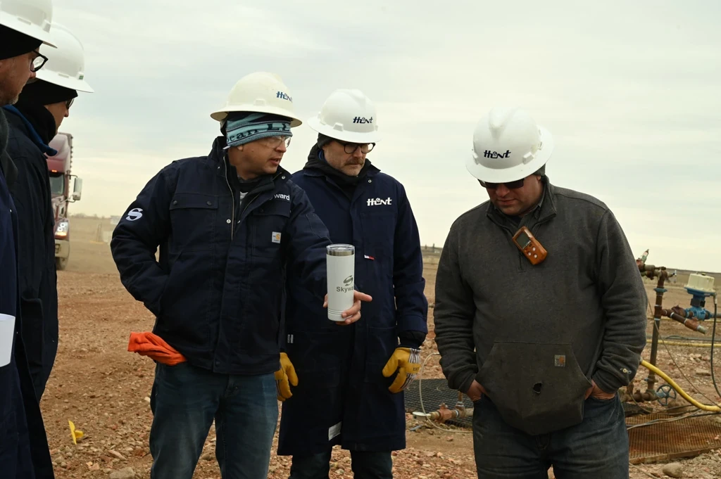 Skyward employees working together in remote field.